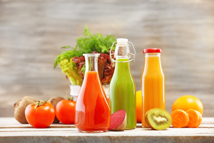 Glass bottles of fresh healthy juice with set of fruits and